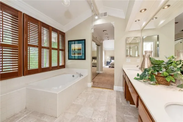 a spacious bathroom with a granite countertop tub and a large window
