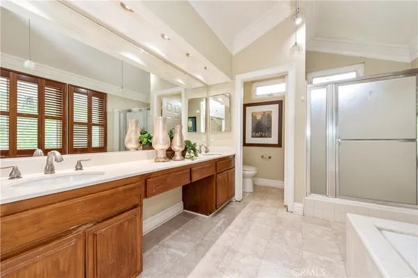 a large bathroom with a large mirror vanity and shower