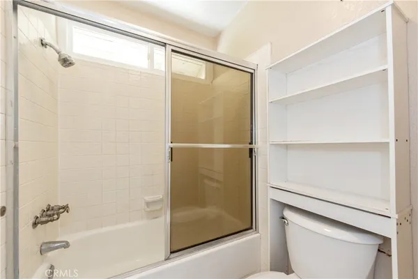 a bathroom with a glass shower door