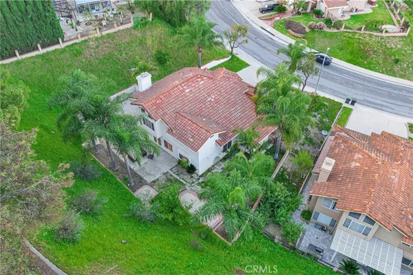 an aerial view of a house with outdoor space pool seating area and yard