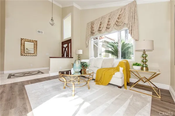 a living room with furniture and a wall painting