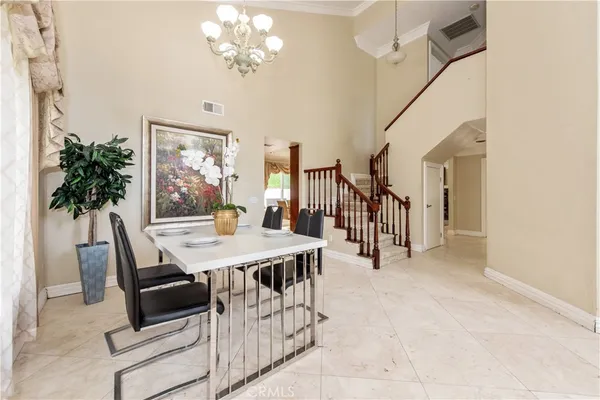 a dining room with furniture and chandelier