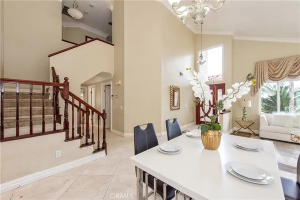 a view of a dining room with furniture and a chandelier