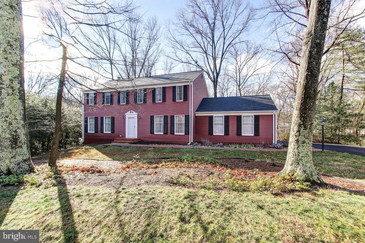 11419 Running Cedar Road Reston, VA 20191 - Photo 1 of 30 a red brick house with trees in front of it