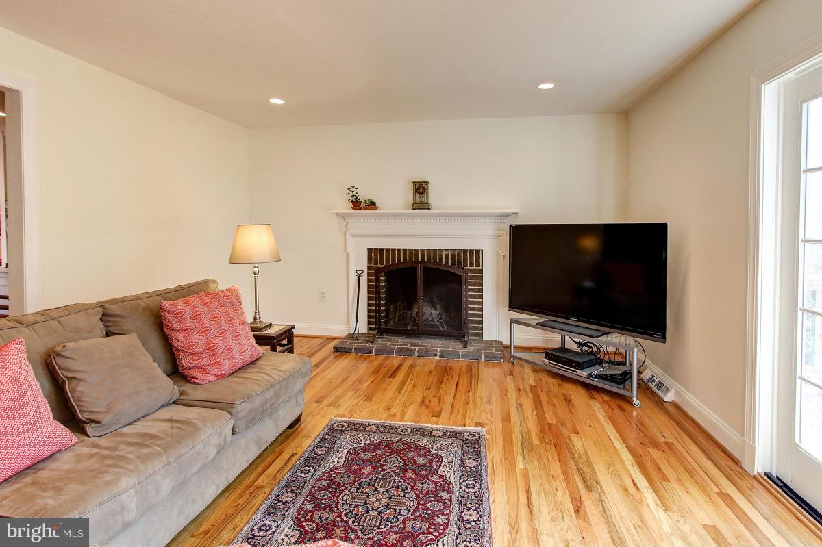 11419 Running Cedar Road Reston, VA 20191 - Photo 11 of 30 a living room with furniture and a flat screen tv