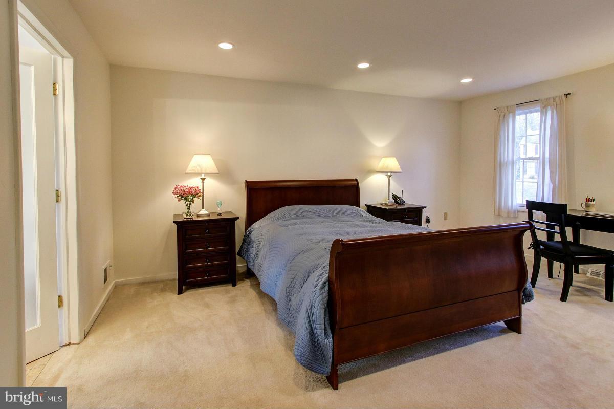11419 Running Cedar Road Reston, VA 20191 - Photo 12 of 30 a bedroom with a bed and lamp with window
