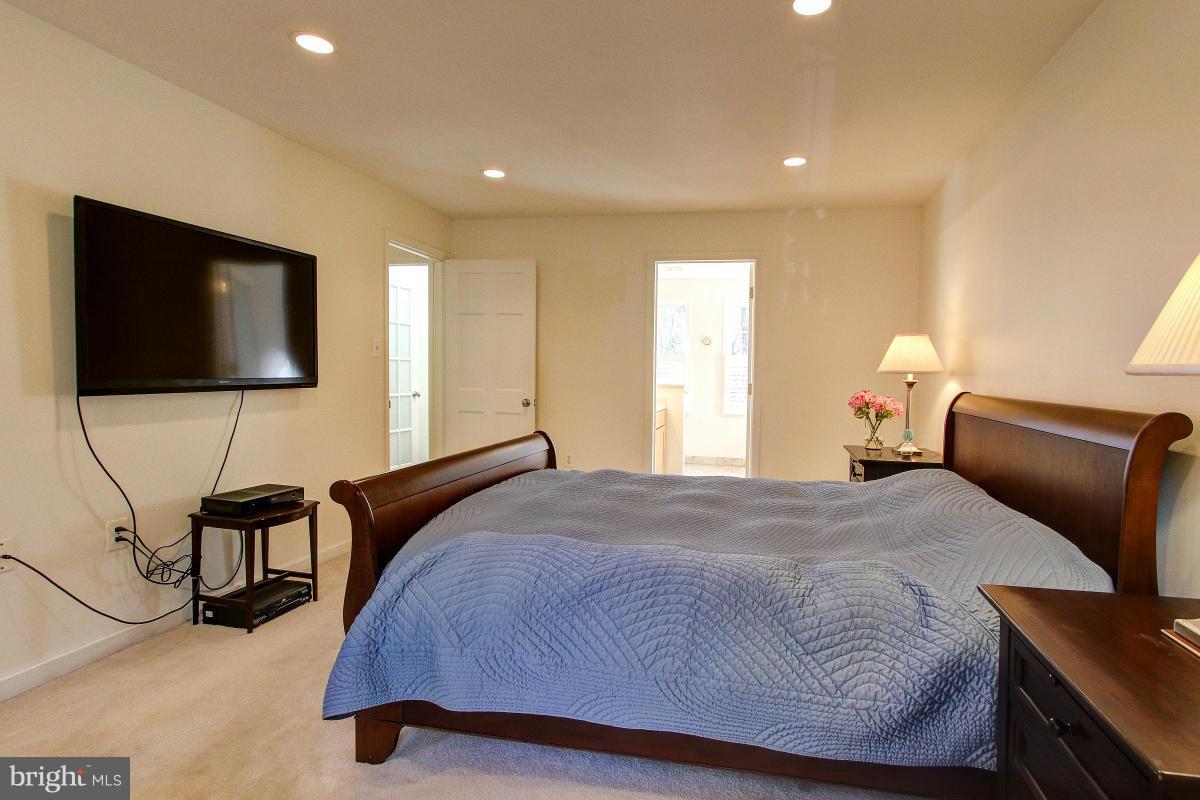 11419 Running Cedar Road Reston, VA 20191 - Photo 13 of 30 a bedroom with a bed tv and chair