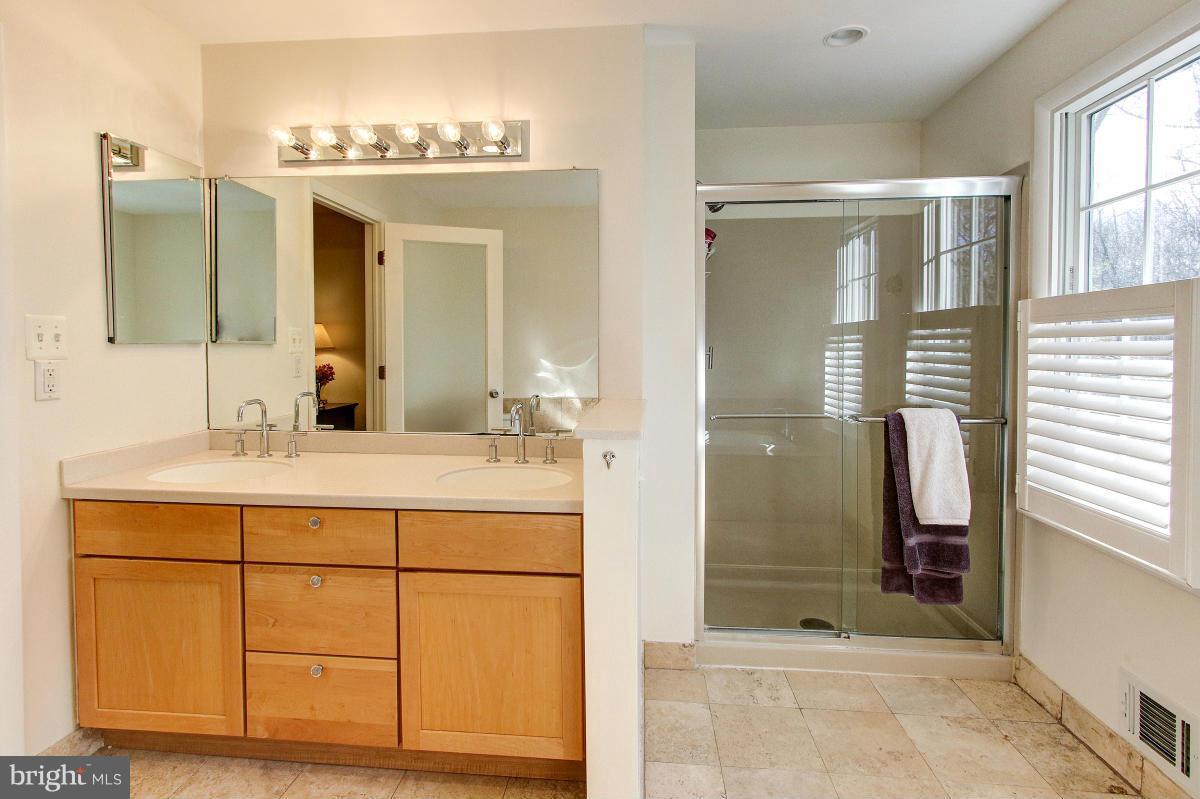 11419 Running Cedar Road Reston, VA 20191 - Photo 16 of 30 a bathroom with a sink a mirror and a shower