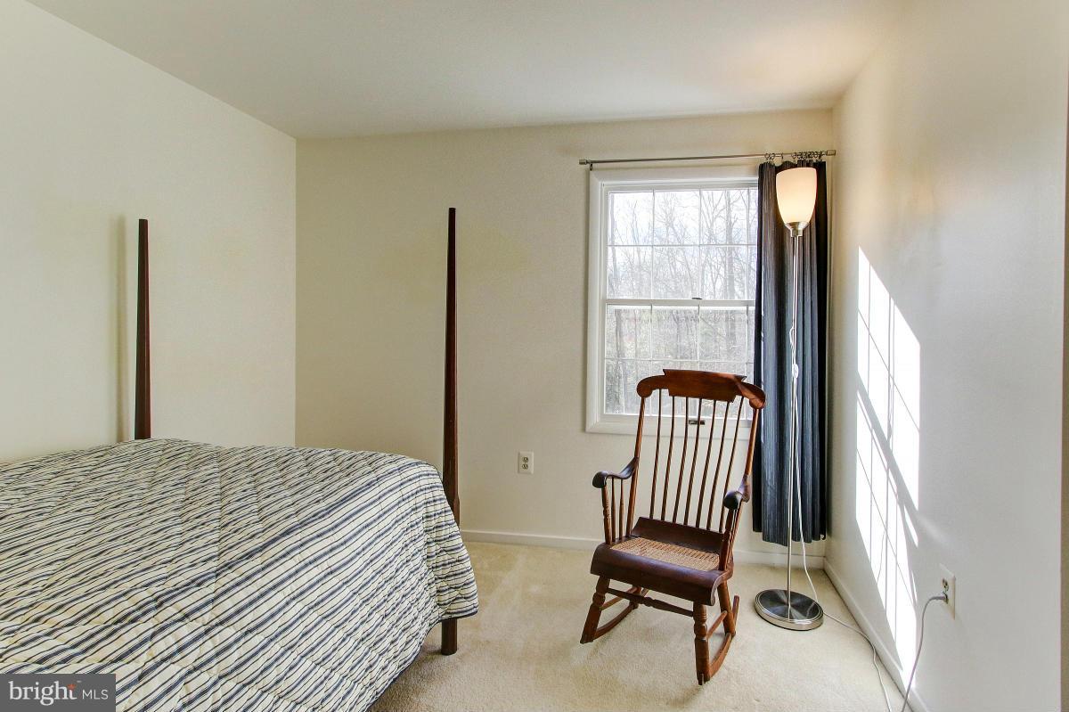 11419 Running Cedar Road Reston, VA 20191 - Photo 20 of 30 a bedroom with a window and chair