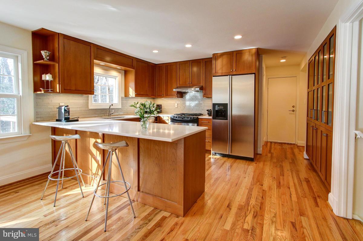 11419 Running Cedar Road Reston, VA 20191 - Photo 6 of 30 a kitchen with stainless steel appliances a microwave a stove a sink dishwasher and cabinets with wooden floor