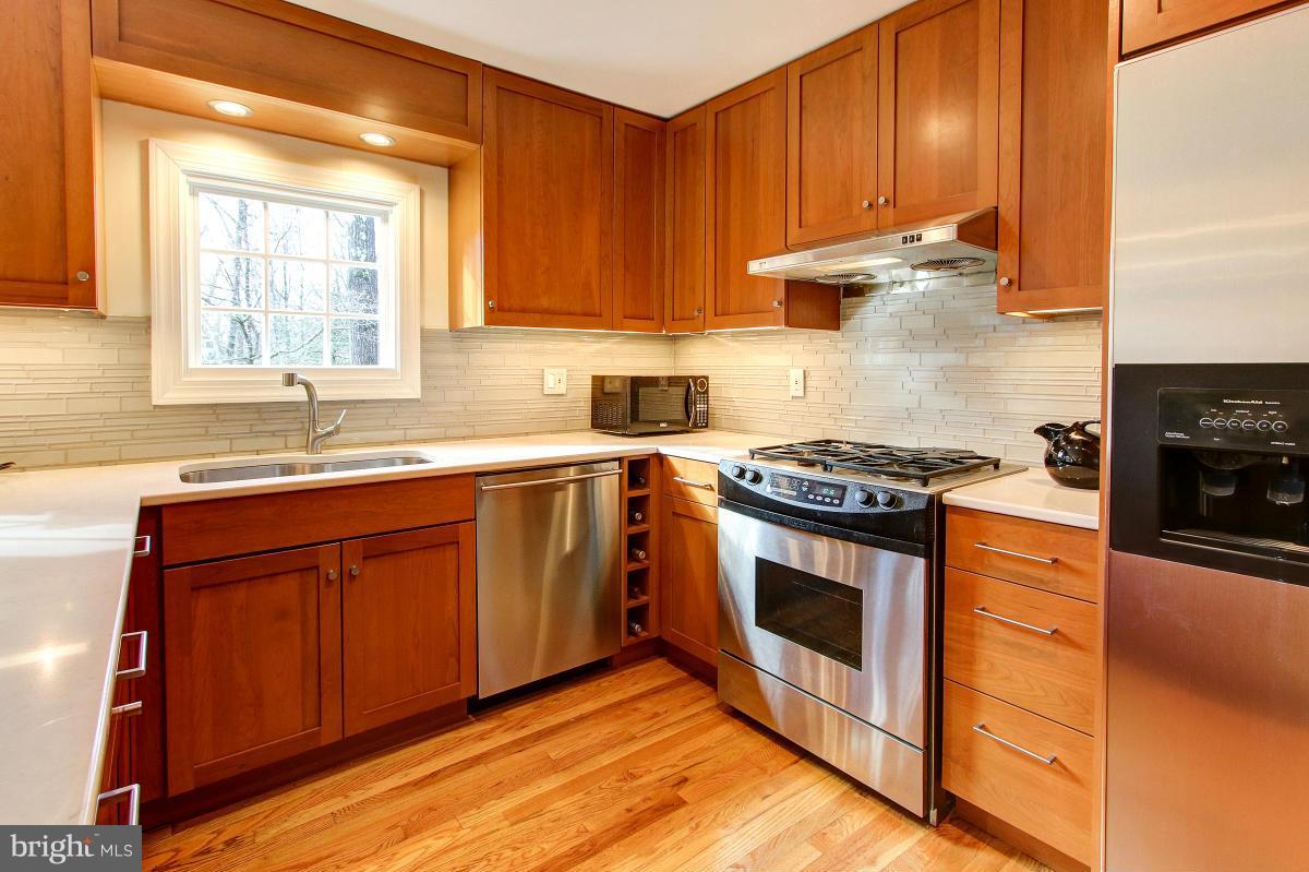11419 Running Cedar Road Reston, VA 20191 - Photo 7 of 30 a kitchen with stainless steel appliances granite countertop a stove a sink and a microwave