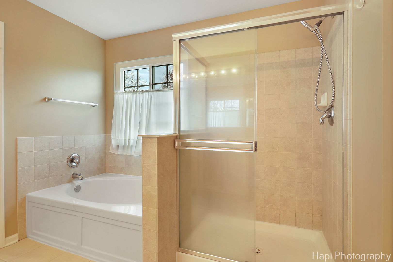 123 Norman Drive McHenry, IL 60050 - Photo 27 of 33 a bathroom with a bathtub a shower a sink and a window