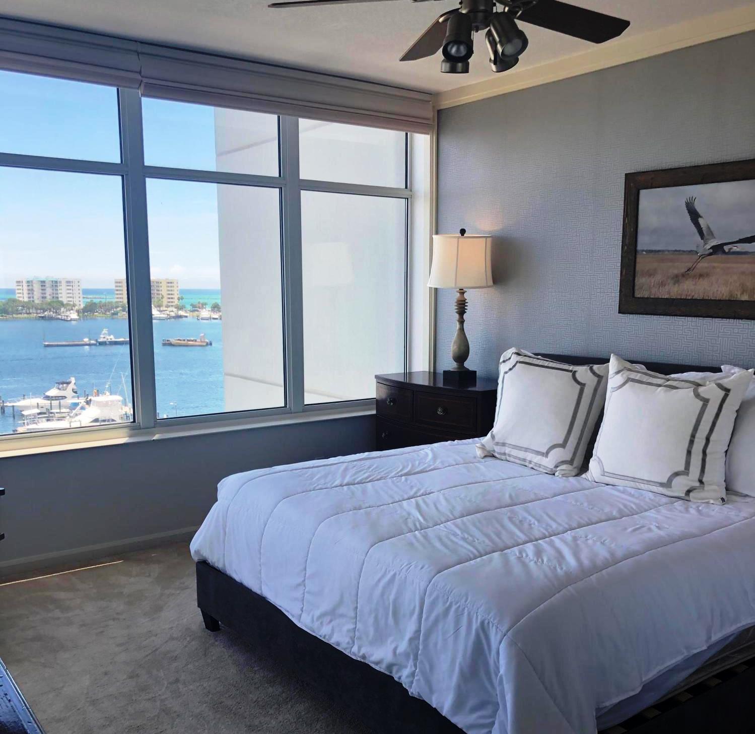 320 Harbor Boulevard, Unit 502 Destin, FL 32541 - Photo 14 of 22 a bedroom with a large bed and a window
