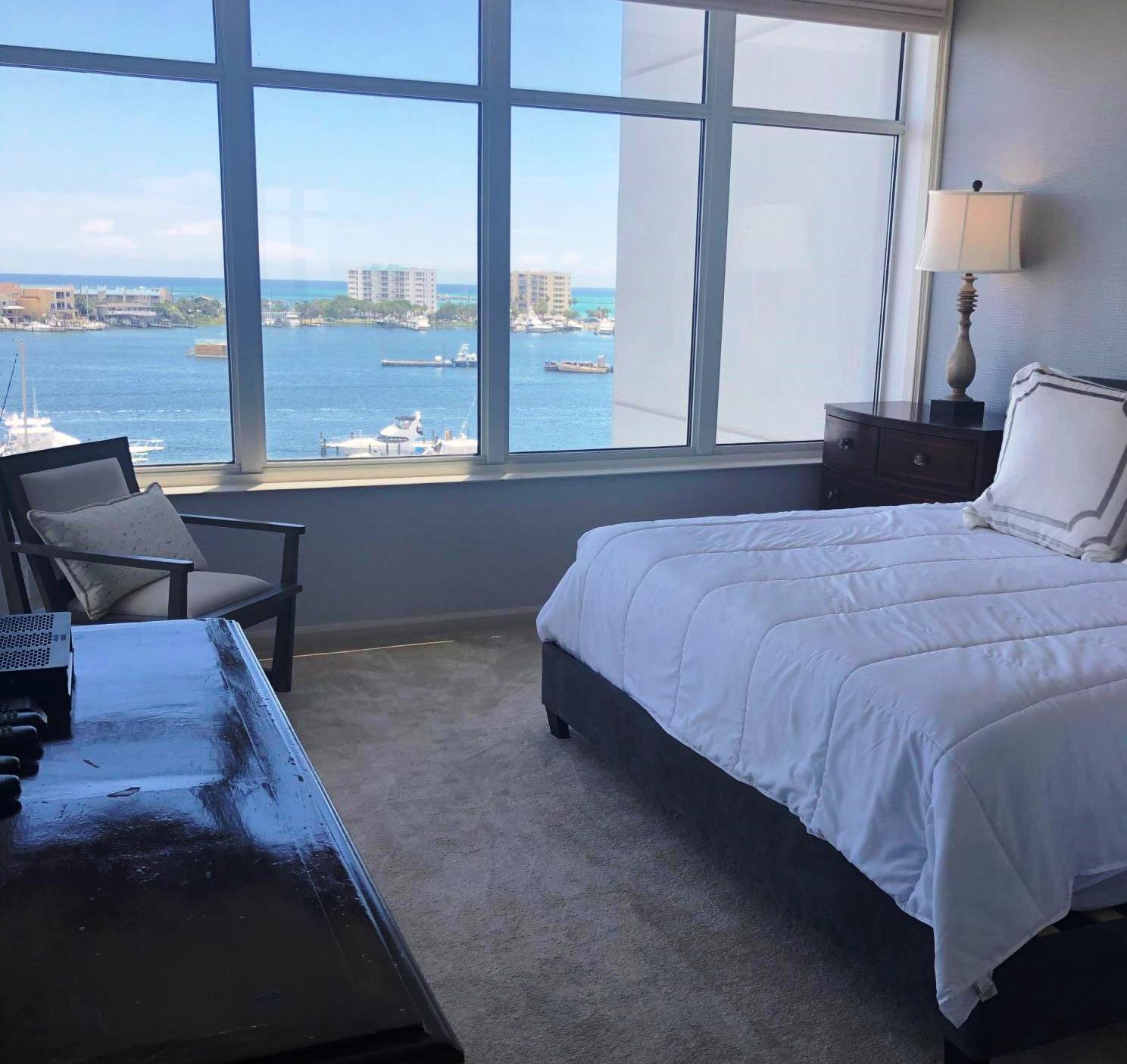 320 Harbor Boulevard, Unit 502 Destin, FL 32541 - Photo 15 of 22 a bedroom with a bed and window