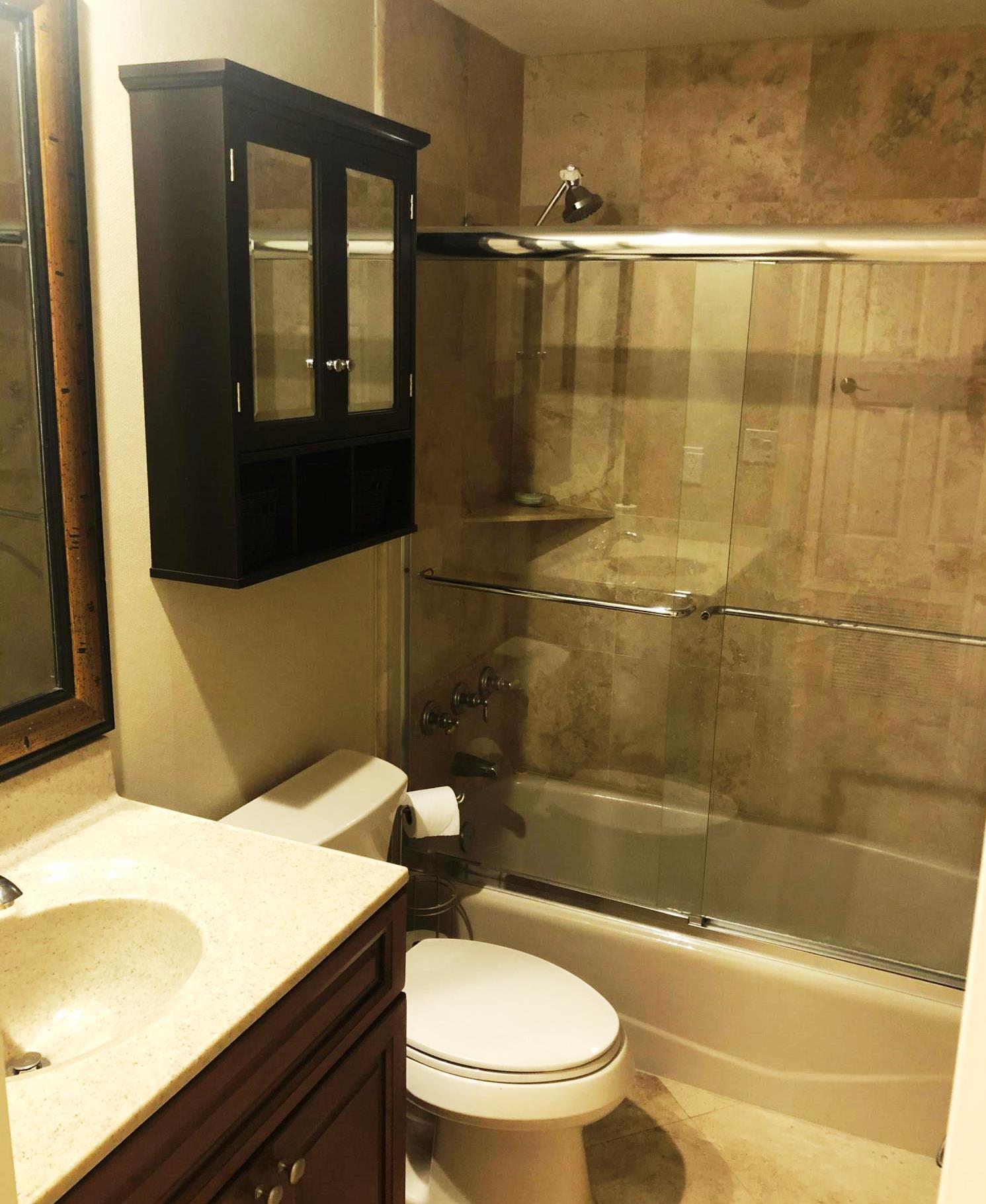 320 Harbor Boulevard, Unit 502 Destin, FL 32541 - Photo 18 of 22 a bathroom with a sink a toilet and shower