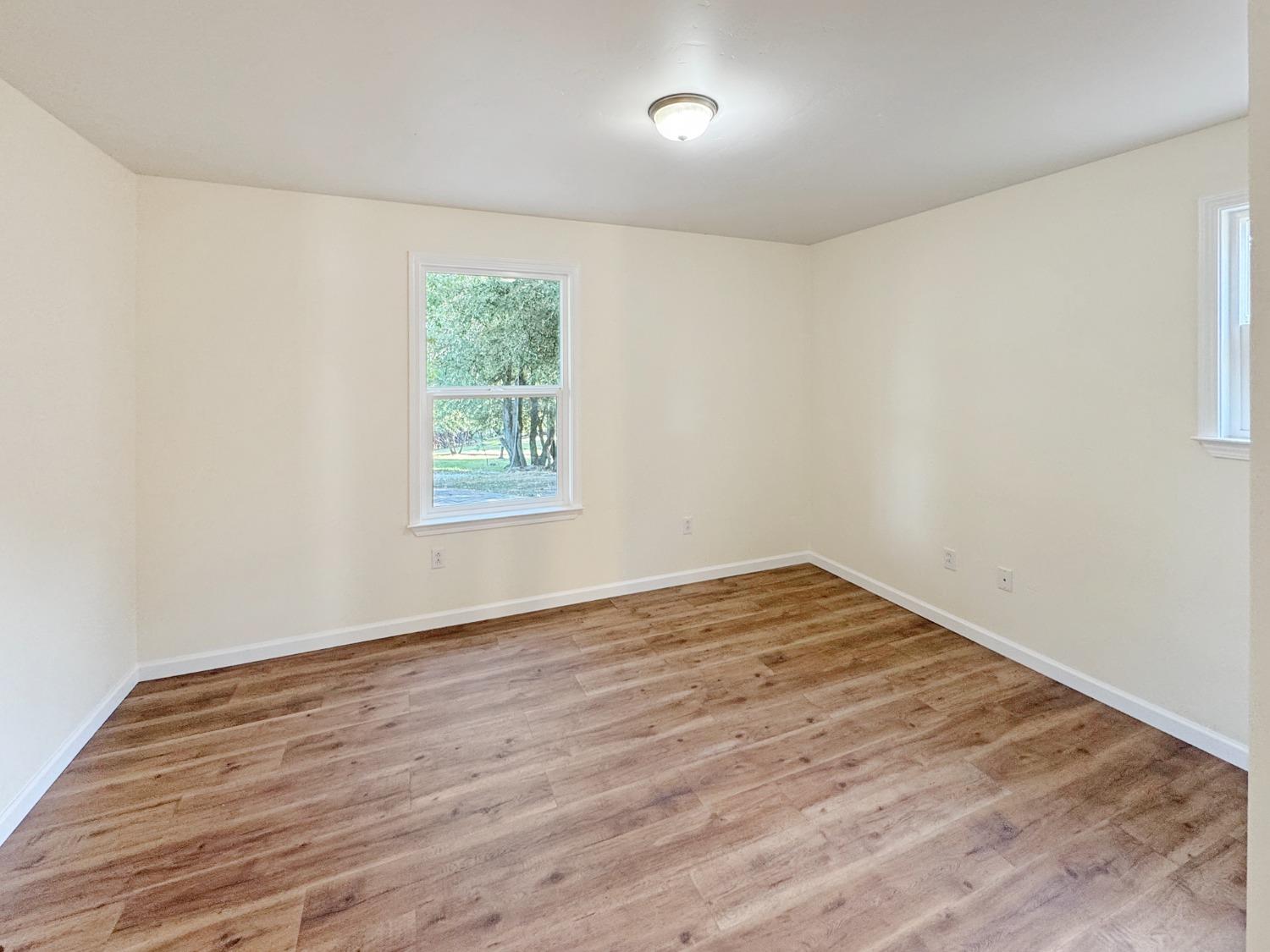 10095 Birchville Road Nevada City, CA 95959 - Photo 11 of 38 a view of an empty room with wooden floor and a window