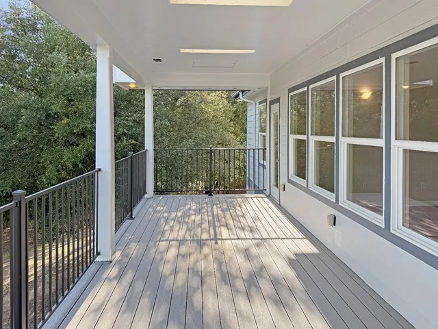 a view of balcony with floor to ceiling window and wooden floor