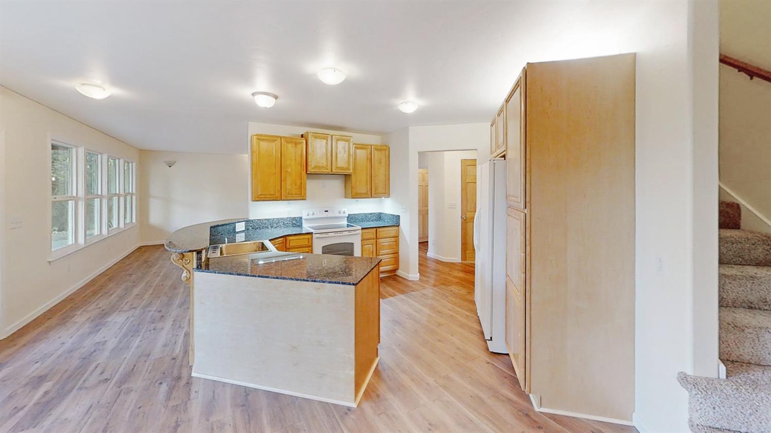 10095 Birchville Road Nevada City, CA 95959 - Photo 15 of 38 a kitchen with stainless steel appliances granite countertop a refrigerator a stove and a wooden floors