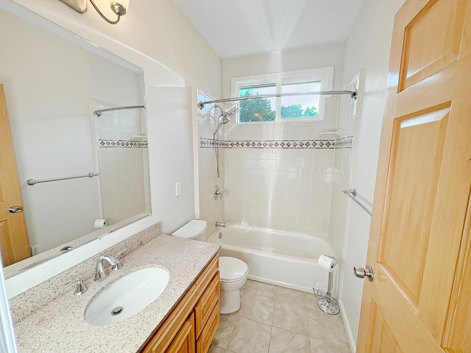 10095 Birchville Road Nevada City, CA 95959 - Photo 20 of 38 a bathroom with a granite countertop sink mirror vanity and a bathtub