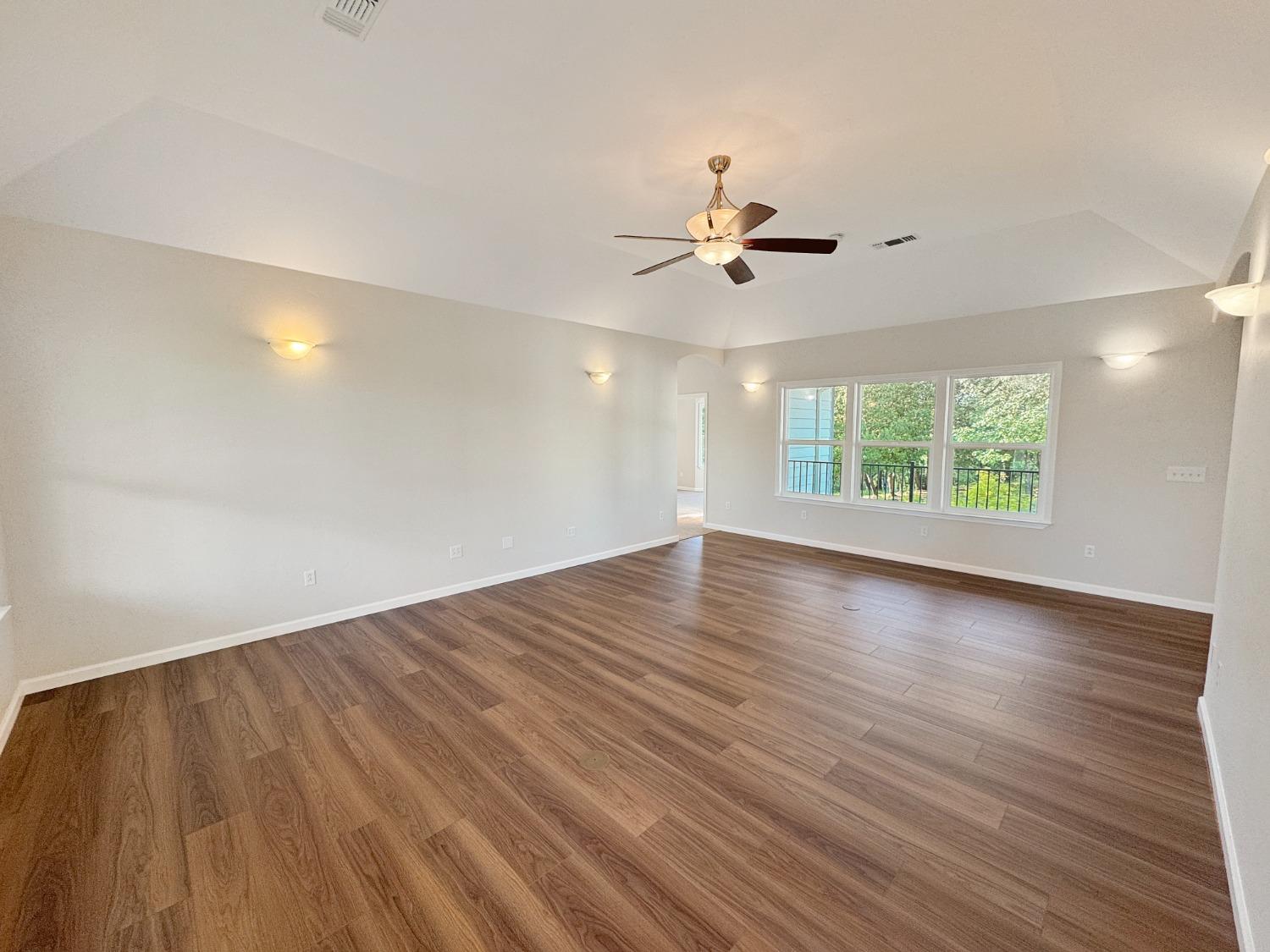 10095 Birchville Road Nevada City, CA 95959 - Photo 5 of 38 a view of an empty room with a window and wooden floor