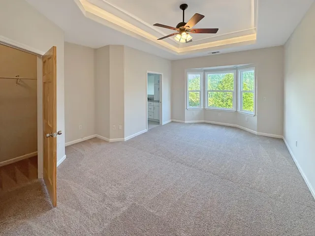 a view of a room with a ceiling fan and a window