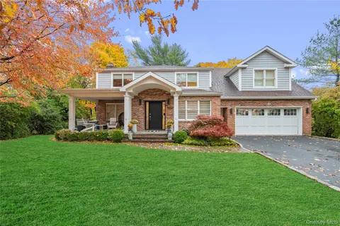 a front view of a house with a garden and porch