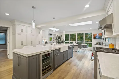 an open kitchen with stainless steel appliances granite countertop a lot of counter space and wooden floors