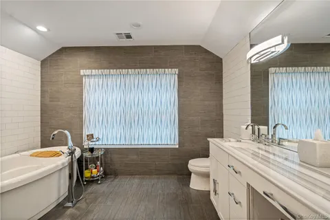 a bathroom with a sink a toilet and bathtub
