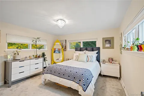 a bedroom with a bed and a large window