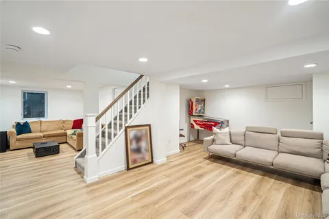 a living room with furniture and stairs