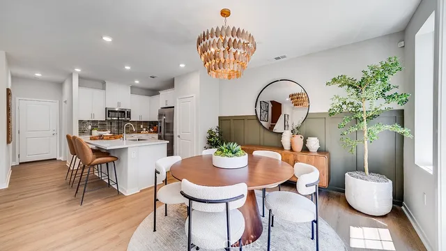 a kitchen with a dining table and chairs