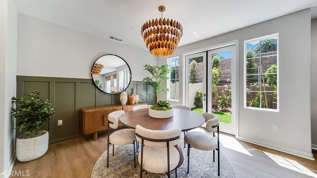 a dining room with furniture a potted plant and a chandelier
