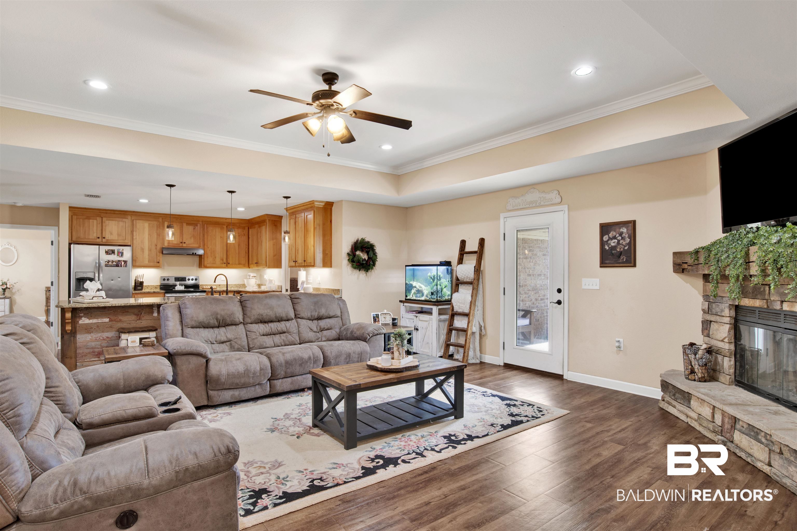 13676 Styx River Road Stapleton, AL 36578 - Photo 6 of 30 Living room featuring ceiling fan, a raised ceiling, ornamental molding, and dark wood-type flooring