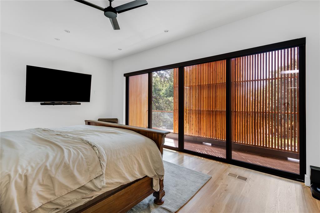 3609 Springbrook Street Dallas, TX 75205 - Photo 11 of 13 a bedroom with a bed and a flat tv screen on the dresser