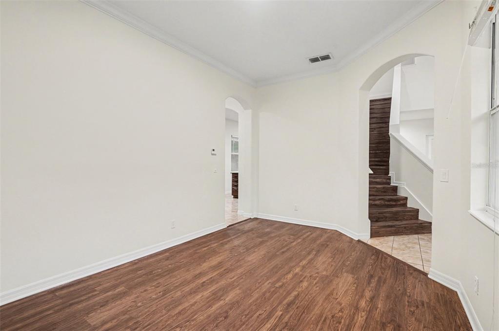 4819 Indian Deer Road Windermere, FL 34786 - Photo 6 of 30 a view of a room with wooden floor and stairs