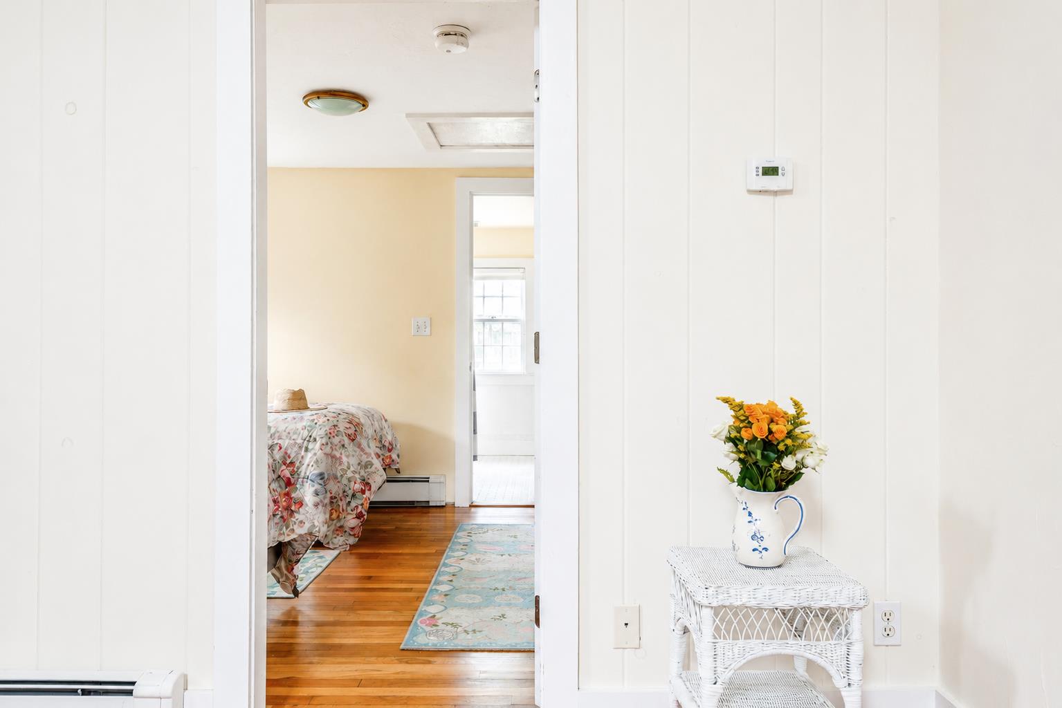 12 King Street Nantucket, MA 02554 - Photo 14 of 32 a view of a bedroom with wooden floor and a potted plant