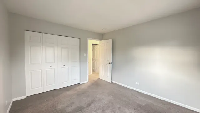 a view of an empty room and closet area
