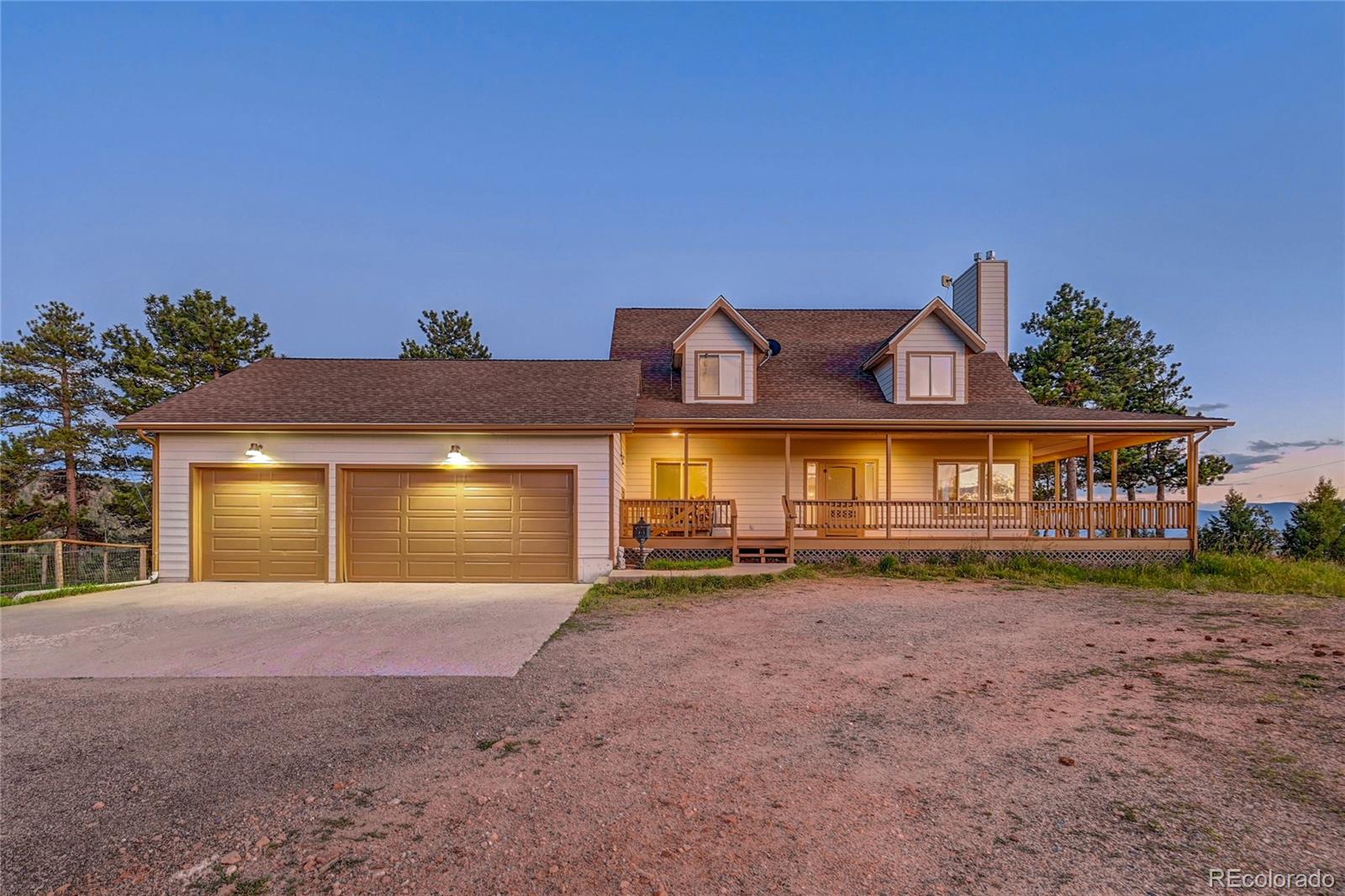 a view of a house with a yard and garage