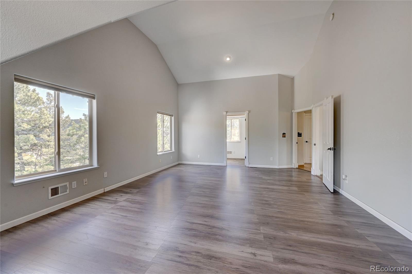13093 Lori Drive Conifer, CO 80433 - Photo 15 of 36 a view of an empty room with wooden floor and a window