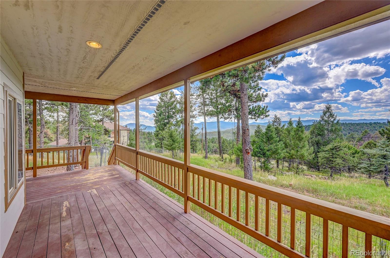 13093 Lori Drive Conifer, CO 80433 - Photo 22 of 36 a view of a balcony with wooden floor