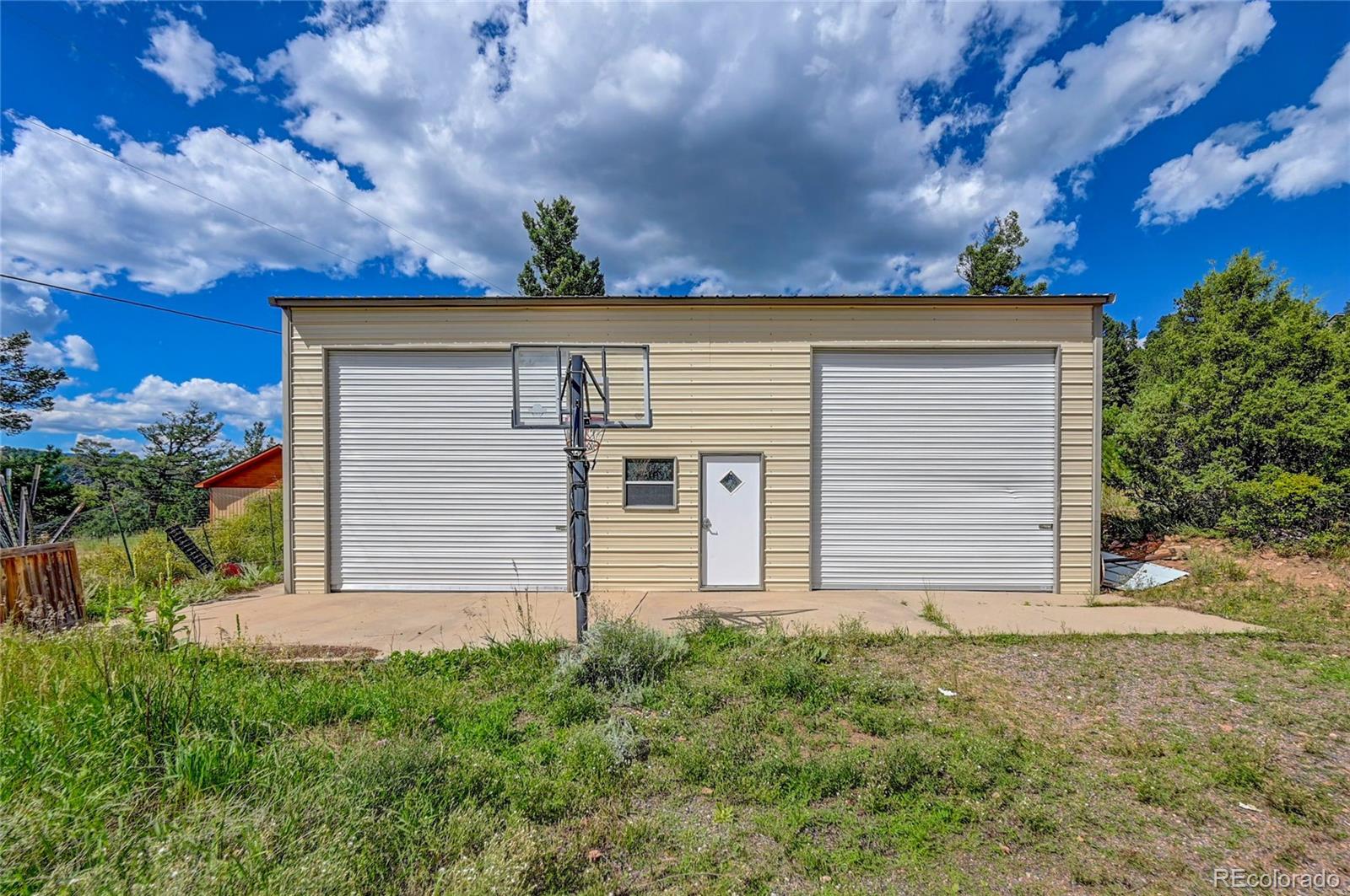 13093 Lori Drive Conifer, CO 80433 - Photo 23 of 36 front view of house with a yard