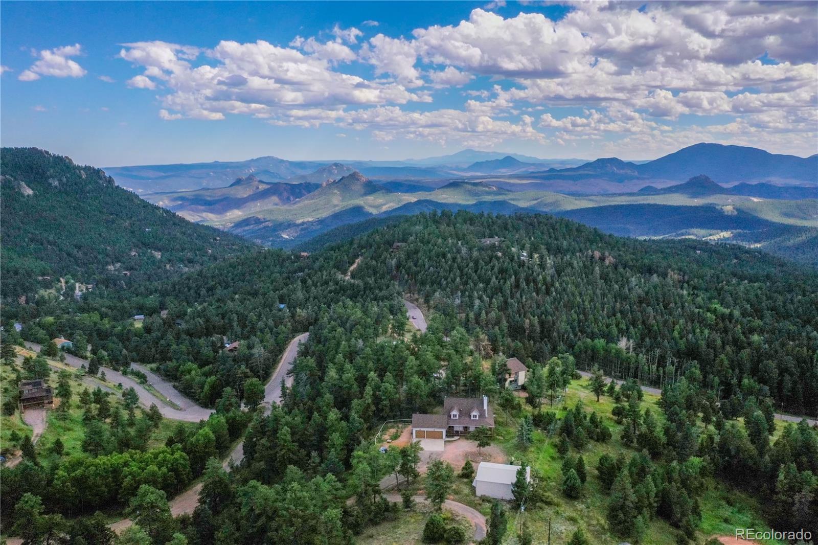 13093 Lori Drive Conifer, CO 80433 - Photo 29 of 36 a view of a city with mountains in the background