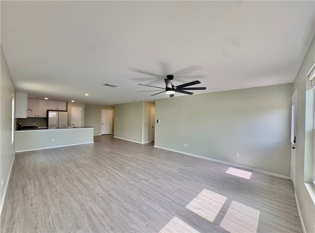 1109 Demeter Drive Portland, TX 78374 - Photo 7 of 18 wooden floor in an empty room with a window