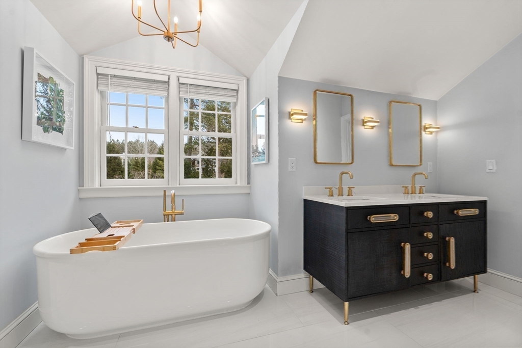 389 Grove Street Needham, MA 02492 - Photo 15 of 40 a bathroom with a tub sink and mirror