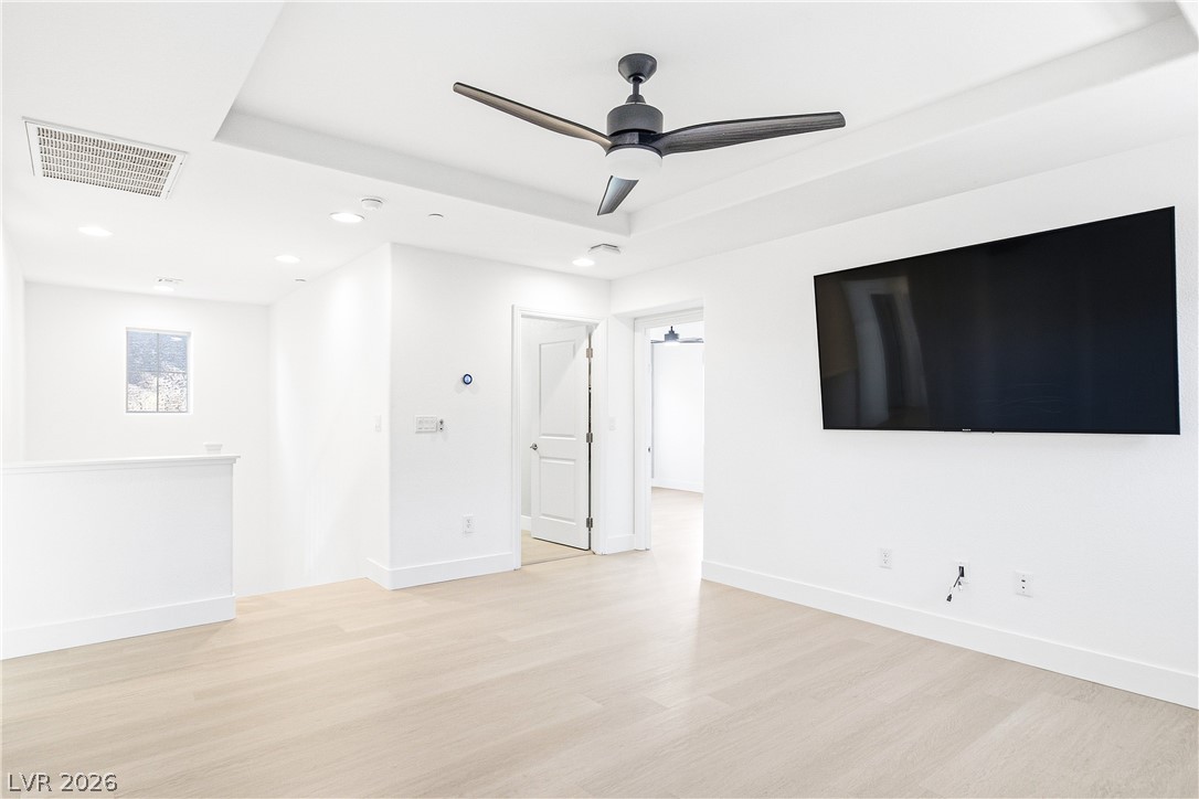 2182 Trivero Street Henderson, NV 89044 - Photo 26 of 50 Recessed lighting and hardwood flooring define this open loft space.