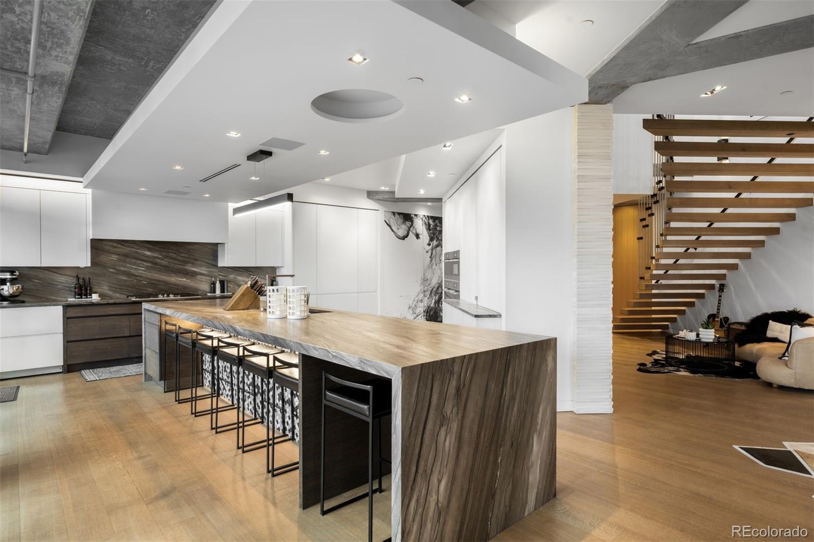 1610 Little Raven Street, Unit PH6 Denver, CO 80202 - Photo 11 of 41 a kitchen with stainless steel appliances granite countertop a stove and a refrigerator