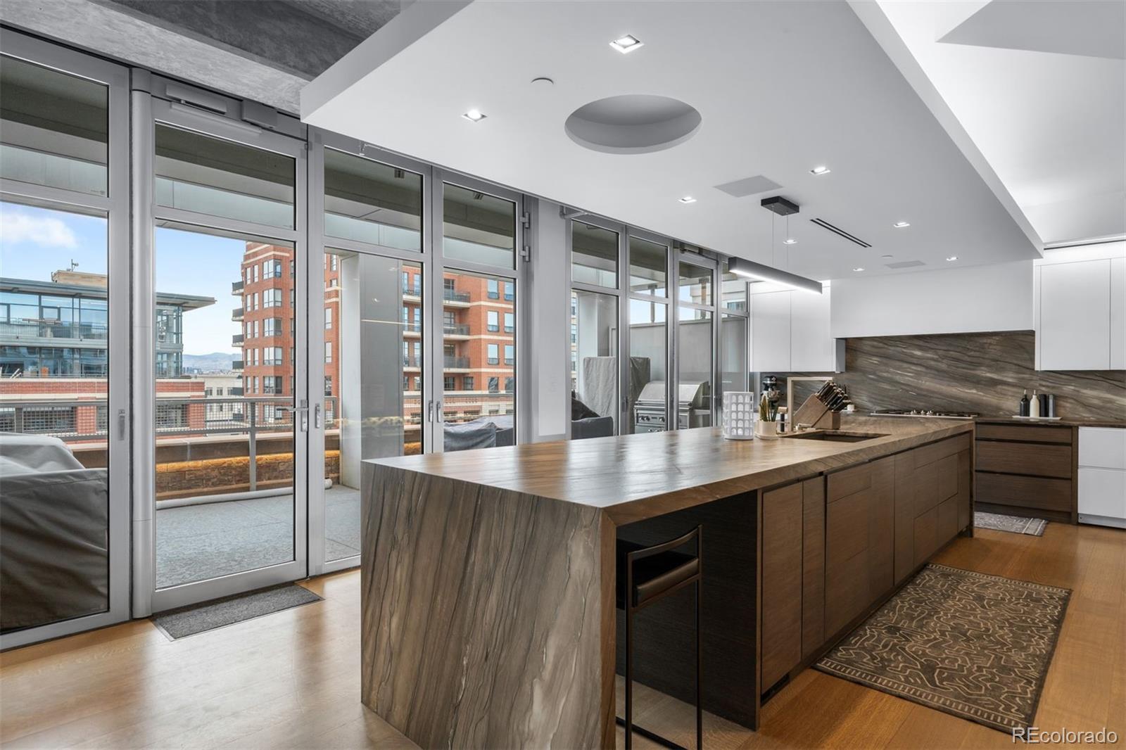 1610 Little Raven Street, Unit PH6 Denver, CO 80202 - Photo 12 of 41 a kitchen with stainless steel appliances granite countertop a sink and a stove