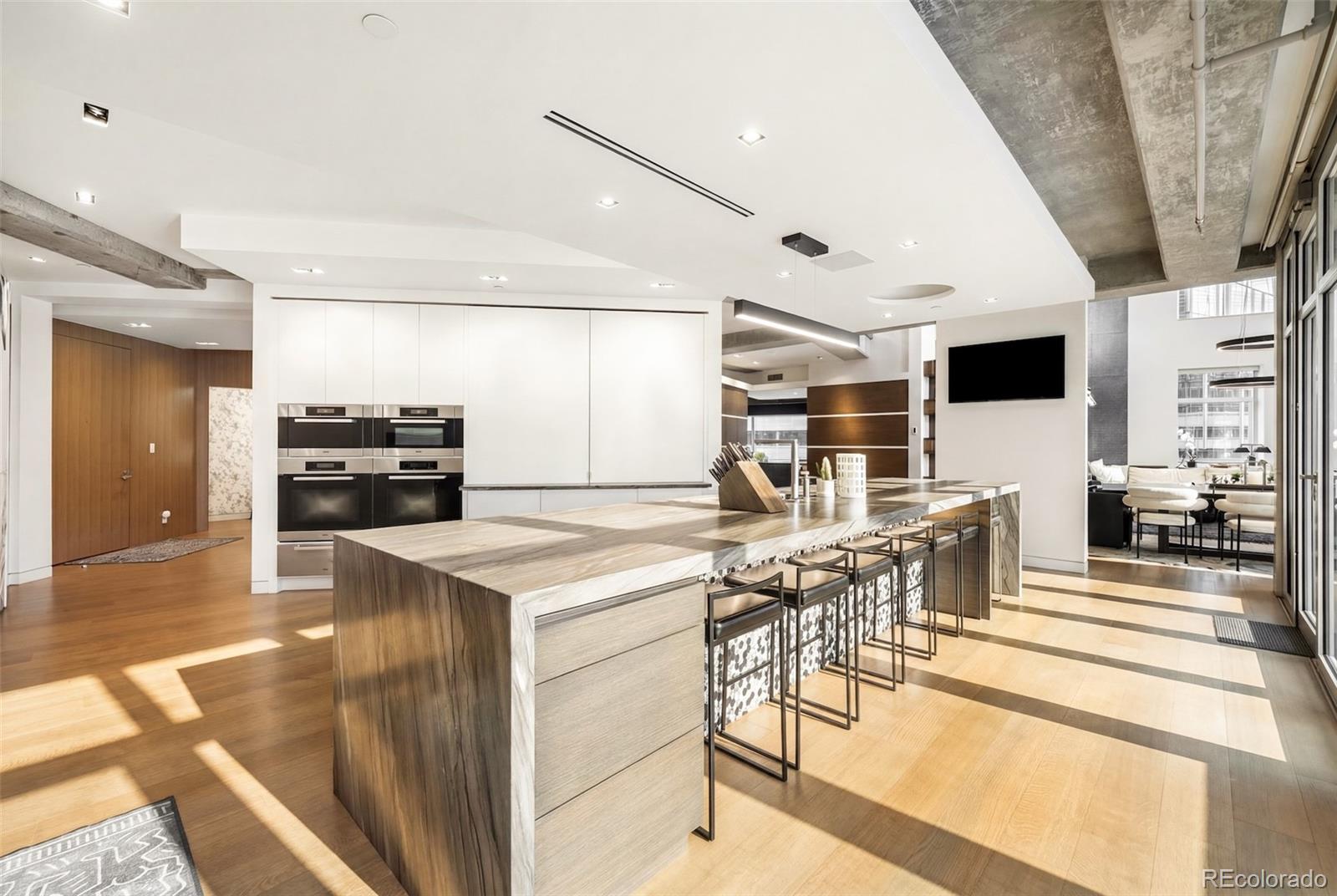 1610 Little Raven Street, Unit PH6 Denver, CO 80202 - Photo 13 of 41 a view of a kitchen with furniture and wooden floor