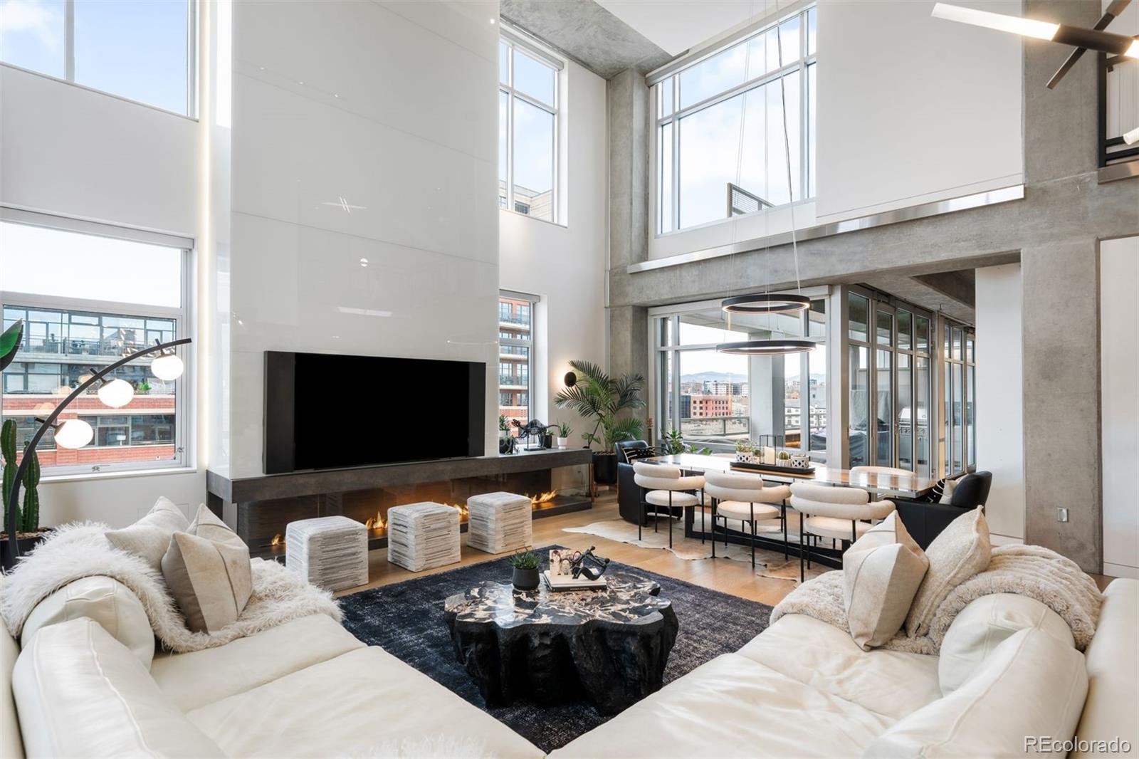1610 Little Raven Street, Unit PH6 Denver, CO 80202 - Photo 2 of 41 a living room with furniture fireplace and a large window
