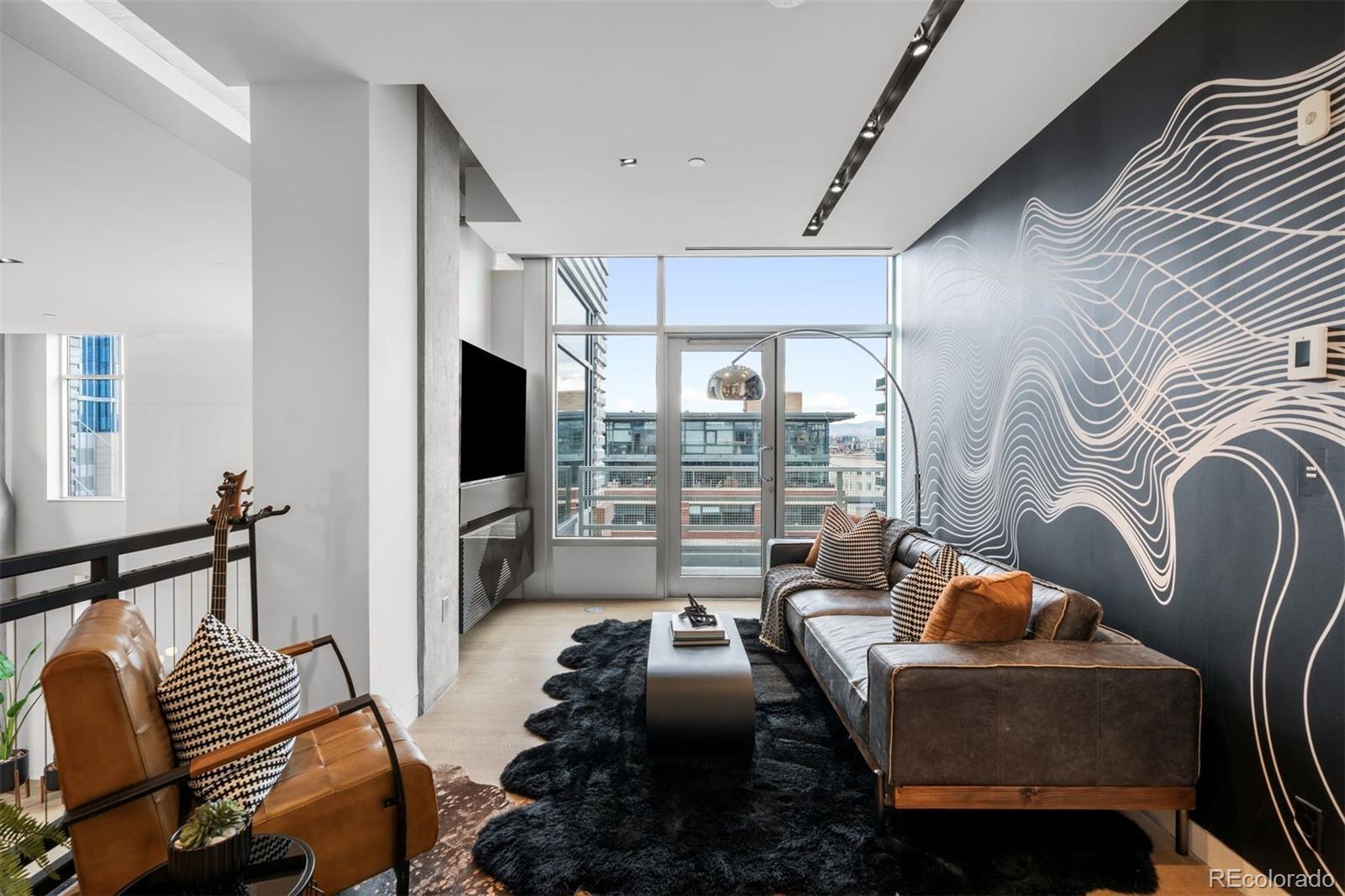 1610 Little Raven Street, Unit PH6 Denver, CO 80202 - Photo 22 of 41 a living room with furniture and a flat screen tv